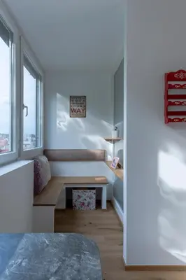 a living room with a bench and a window at TAMLiving Ljubljana 2BR Center 3 Bridges Great View Kitchen in Ljubljana