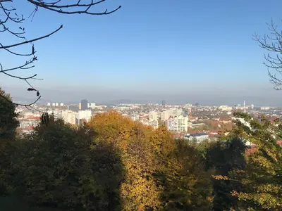 a view of a city from a hill with trees at TAMLiving Ljubljana 2BR Center 3 Bridges Great View Kitchen in Ljubljana