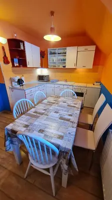 a kitchen with a wooden table and chairs in a kitchen at Valant Apartment ID I00070 in Bled