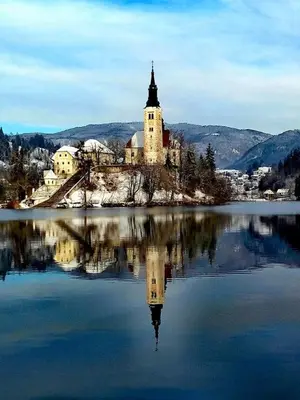 a building on an island in the middle of a lake at Valant Apartment ID I00070 in Bled