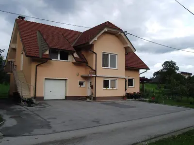 a large house with a garage in a driveway at Valant Apartment ID I00070 in Bled