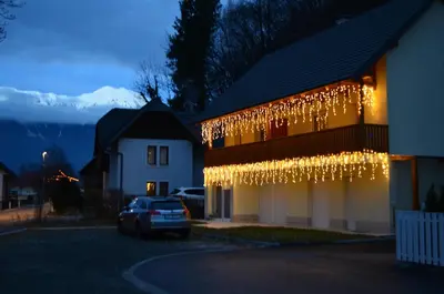 a building with christmas lights on the side of it at Apartments Sofija in Bled