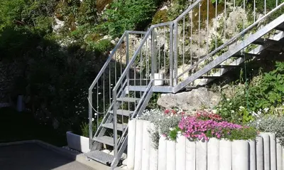 a set of stairs with flowers next to a fence at Apartments Sofija in Bled