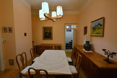 a dining room with a table and a table and chairs at Villa Elasan in Bled