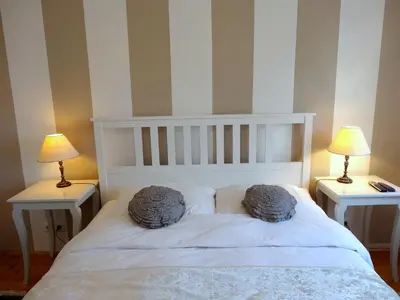 a bedroom with a white bed with two lamps at Villa Elasan in Bled