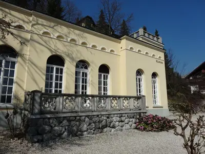 a building with a stone fence in front of it at Villa Elasan in Bled
