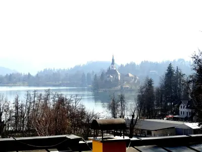 a view of a lake with a church in the distance at Villa Elasan in Bled