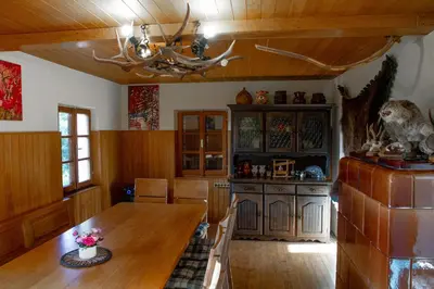 a kitchen with a wooden table and a ceiling at Andy's Holiday Home with HotTub & Sauna in Podbočje