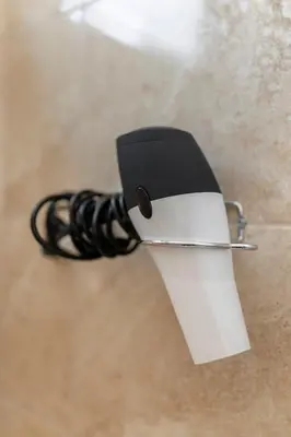 a black and white cup with a rope on the floor at Apartments Berni in Ljubljana