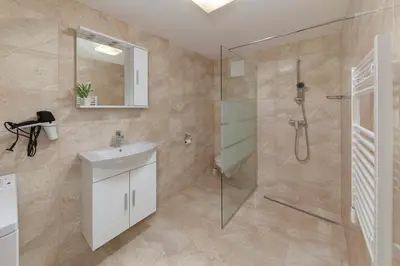 a bathroom with a shower and a sink at Apartments Berni in Ljubljana