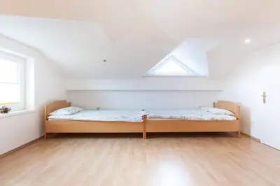 a bedroom with a bed in a room with a window at Bed and Breakfast Špelca in Pivka