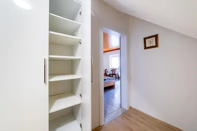 a room with white shelves and a hallway at Bed and Breakfast Špelca in Pivka