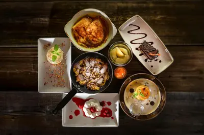 a table with plates of food and bowls of food at Guesthouse Les in Brežice