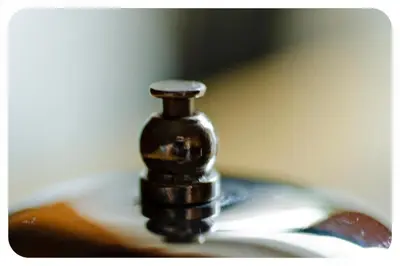 a black bottle sitting on top of a book at Guesthouse Les in Brežice