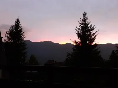 a sunset from the balcony of a house at Apartma Manfreda Bovec in Bovec