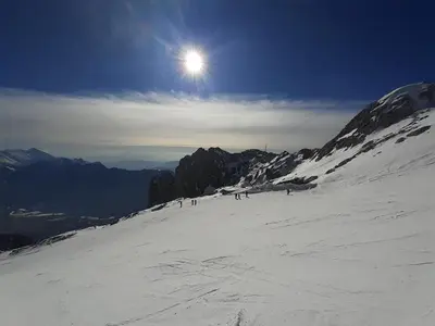 a group of people skiing down a snow covered mountain at Apartma Manfreda Bovec in Bovec