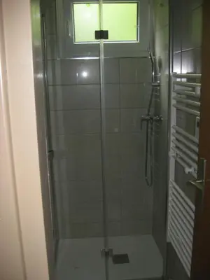 a shower with a glass door in a bathroom at Apartma Manfreda Bovec in Bovec