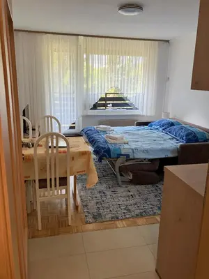 a bedroom with a bed and a table and chairs at Apartma Manfreda Bovec in Bovec