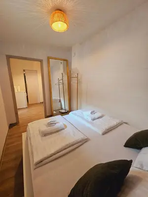 a bedroom with two beds with towels on them at Central Ljubljana Apartment , 150m from Prešeren Square in Ljubljana