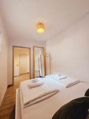 a bedroom with two beds with towels on them at Central Ljubljana Apartment , 150m from Prešeren Square in Ljubljana