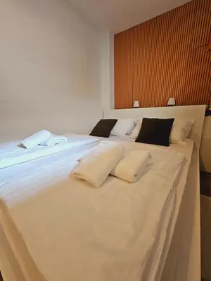 a large white bed with two pillows on it at Central Ljubljana Apartment , 150m from Prešeren Square in Ljubljana