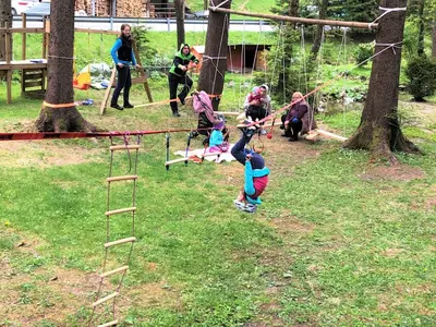 a group of children playing on a swing set in a park at Farmhouse Štiftar in Solčava