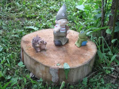 a group of figurines sitting on top of a tree stump at Farmhouse Štiftar in Solčava