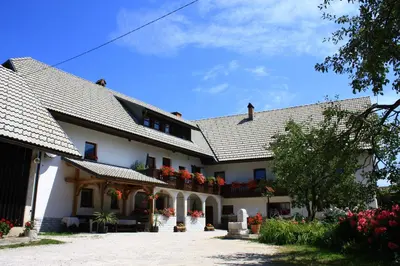 a large white building with flowers on the balconies at Apartments Sušnik in Bohinj