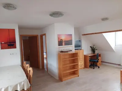 a bedroom with a bed and a desk and a television at Apartments Sušnik in Bohinj