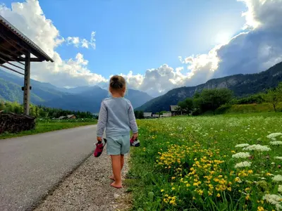 a little girl walking down the road at Apartments Sušnik in Bohinj