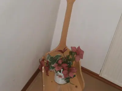 a wooden shelf with a potted plant on it at Apartment Žvan in Bohinj
