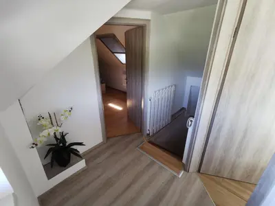 a view of a hallway with a vase of flowers at Apartments Bernard in Bled