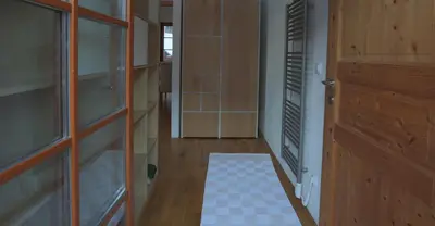 a hallway with a door and a tile floor at Apartment Brina in Kranjska Gora