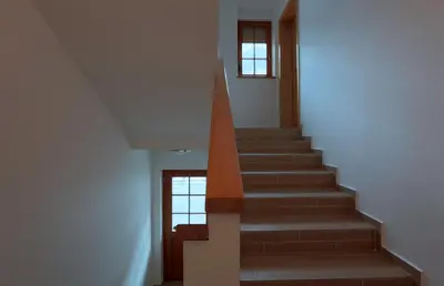 a staircase in a house with a stair case at Apartment Brina in Kranjska Gora
