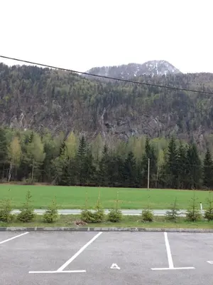 an empty parking lot with a mountain in the background at Apartment Brina in Kranjska Gora