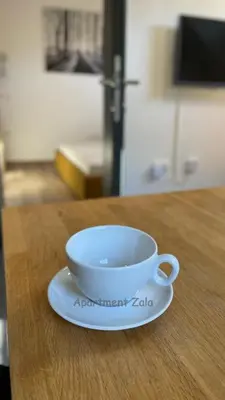 a bowl on a plate on a table at Apartma Zala, Golte in Mozirska Koča