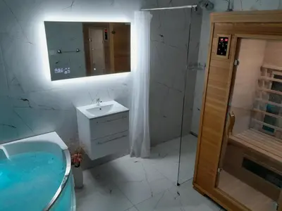 a bathroom with a tub and a sink and a mirror at Farm Stay Frank Ozmec Wine and Glamping estate in Ljutomer