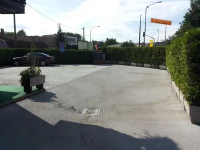 a parking lot with a car parked in it at Prenočišča Kralj in Komenda