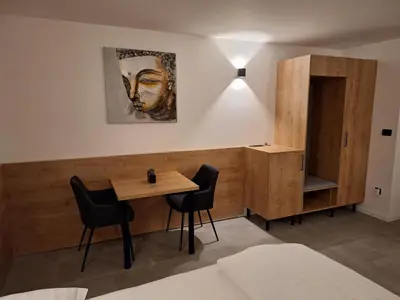 a dining room with a table and chairs at Prenočišča Kralj in Komenda