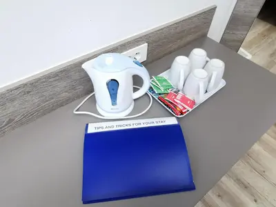 a table with a tea pot and cups on it at Rooms Ambrožič in Ljubljana