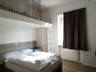 a bedroom with a bed with towels on it at Rooms Ambrožič in Ljubljana