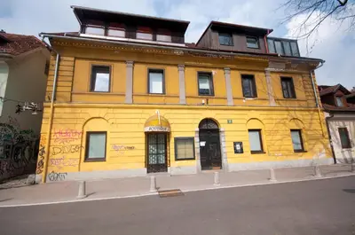 a yellow building on the side of a street at Rooms Ambrožič in Ljubljana