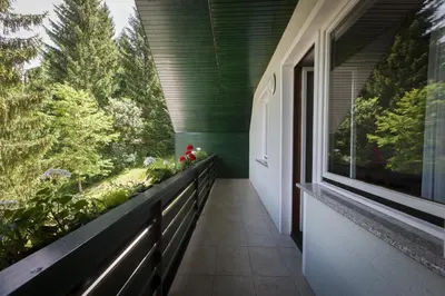 a balcony of a house with a large window at Home with views on Alps in Bohinj