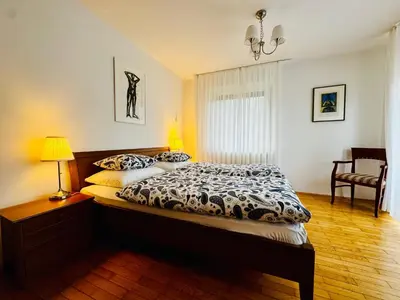 a bedroom with a bed and a table with a lamp at Home with views on Alps in Bohinj