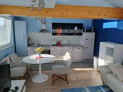 a kitchen with a table and chairs in a room at Apartma Jaka in Ljubljana