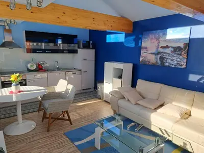 a living room with a white couch and a table at Apartma Jaka in Ljubljana