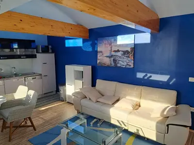 a living room with a white couch and a blue wall at Apartma Jaka in Ljubljana