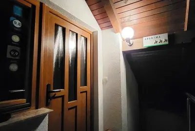 a door in a room with a light next to it at Apartments Oman in Kranjska Gora