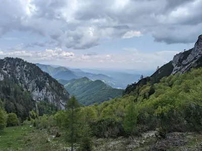 a view of a mountain valley with trees and mountains at M & M apartment Krvavec in Cerklje na Gorenjskem
