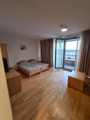 a bedroom with a bed and a sliding glass door at Villa Mari - apartma št. 6 in Maribor
